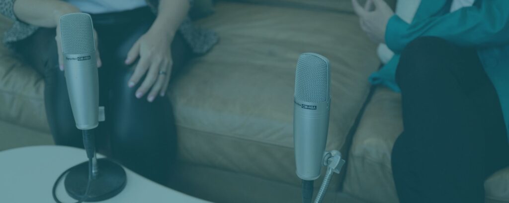 two microphones and two people chatting. Looks like they're recording a podcast